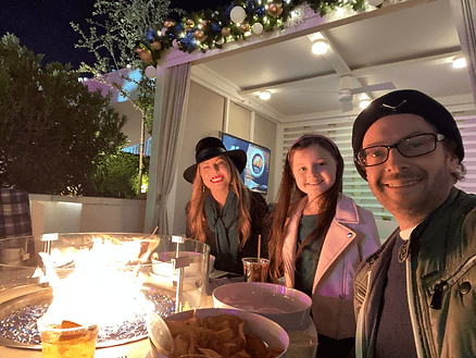 Christianne, Livia, and Dan at their King cabana and fire pit, Fontainebleau Las Vegas. Image by Dan Sattel.
