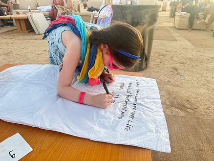 Writing her hopes and dreams on one of two sky lanterns.  Image by Christianne Klein. 