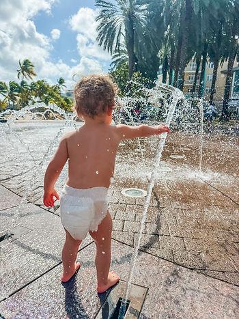 Rose playing in the water near Camana Bay, Grand Cayman.  Image by Katherine Rose Woller. 
