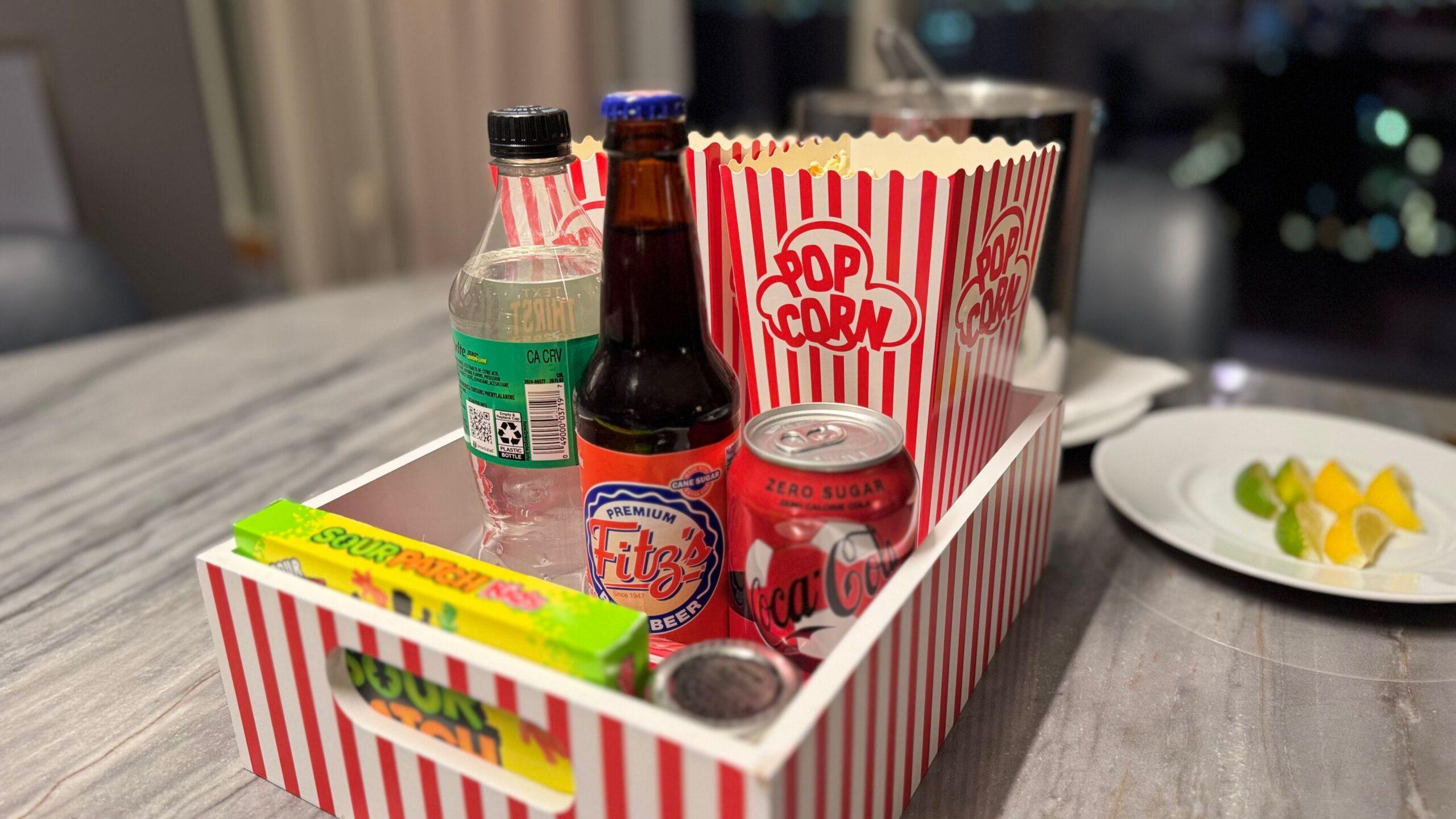 Our in-suite "movie night" included fresh popped butter with drawn butter, sodas, and boxed candies. Image by Christianne Klein