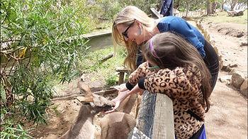 Christianne and Livia hand-feeding kangaroos at Bonorong Animal Sanctuary in Tasmania. Image by author.